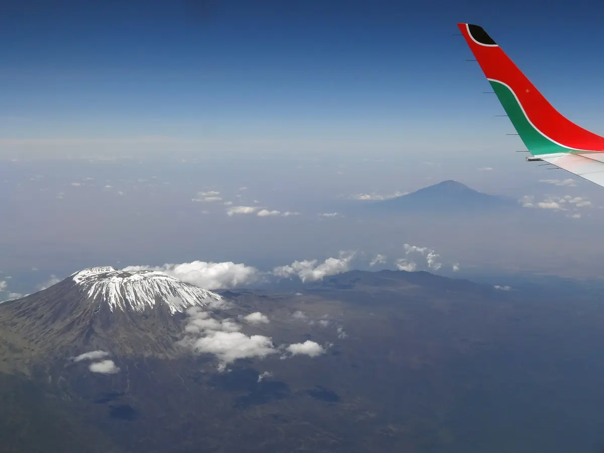 View from a plane window over Kimana and Kilimanjaro with clouds