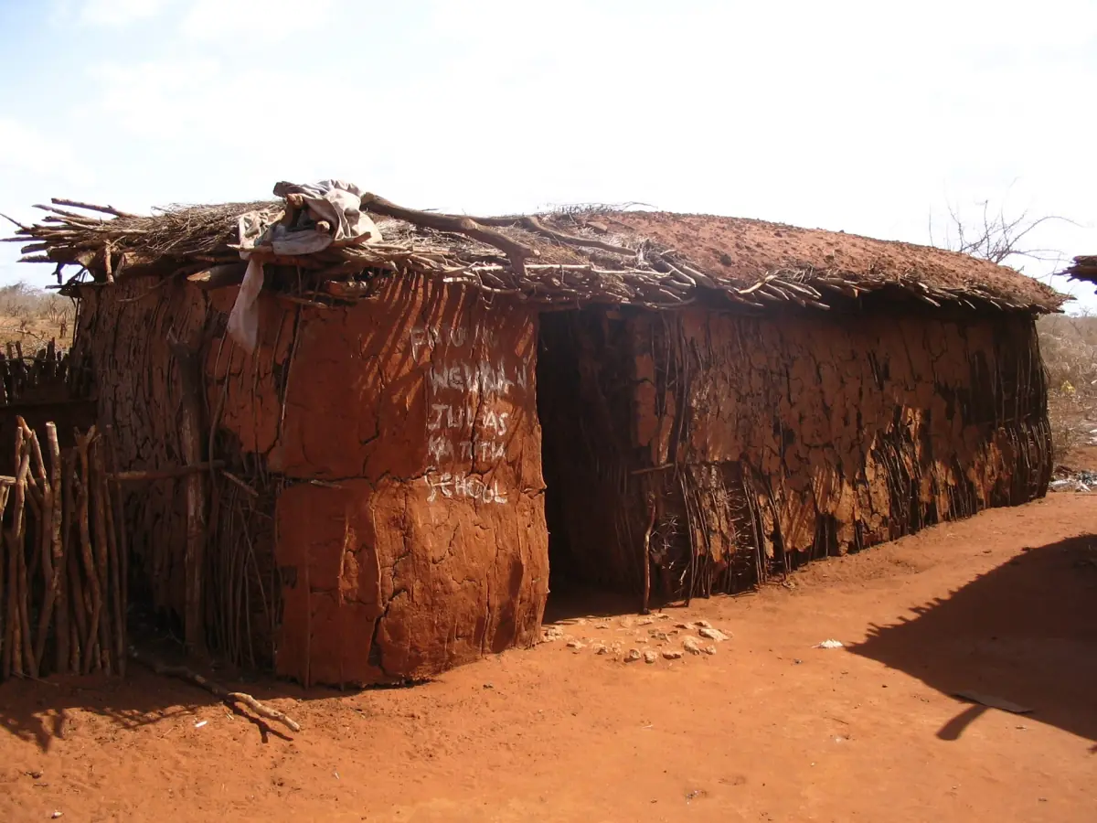 Traditional Maasai hut built from dung and thatch with a thorn fence